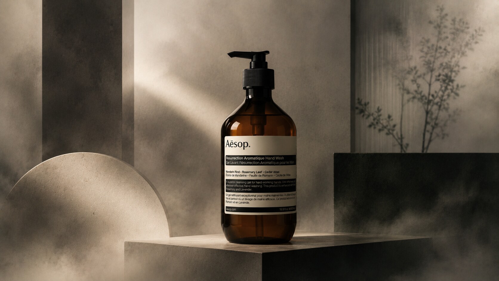 Aesop hand wash bottle in amber plastic or glass with pharmacy-style label and minimalist typography.