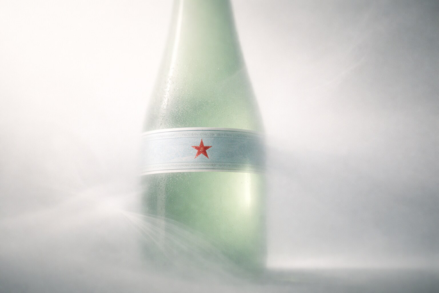 S.Pellegrino packaging uses a green Vichy bottle, red star, and Art Nouveau label language for table recognition.